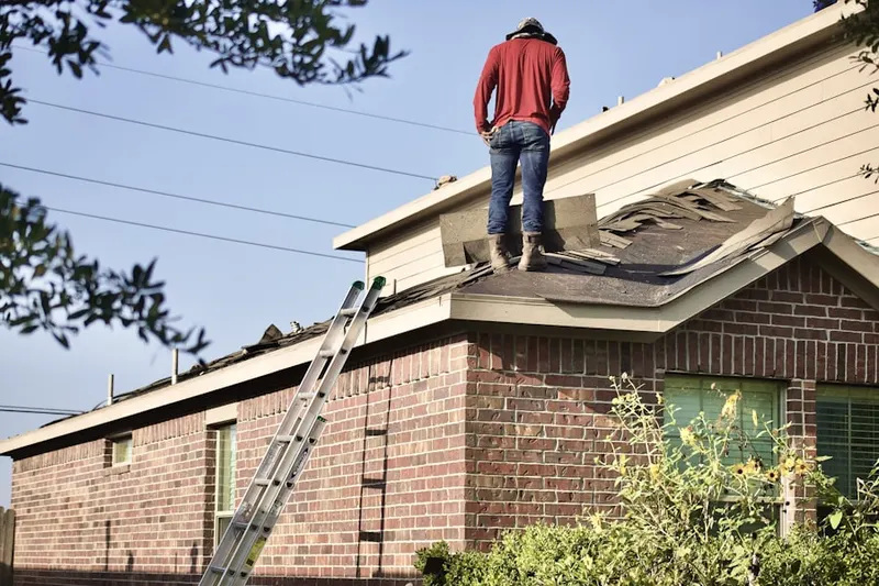 Professional roofer working on a residential roof in Urbandale